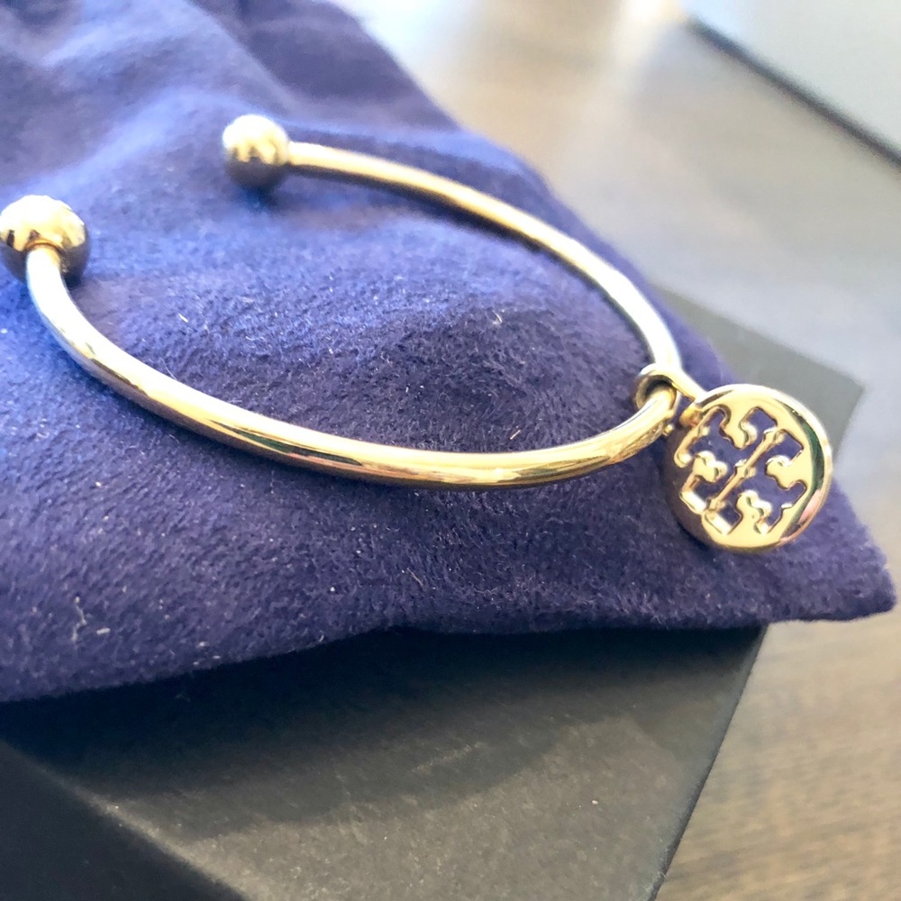 Tory Burch Charm on gold plated bangle.